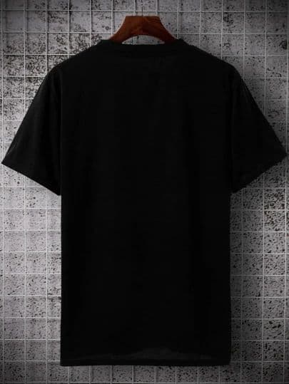 Black T-shirt on a wooden hanger against a tiled wall